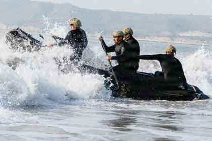 IN THE SURF: Sailors assigned to Explosive Ordnance Disposal Group 1 paddle a rigid-hulled inflatable boat while conducting surf passage training at NAS North Island. U.S. Navy photo by Petty Officer 2nd Class August Clawson.