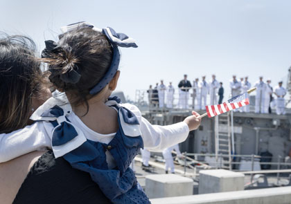SAN DIEGO (Apr. 22, 2025) A family member waves as guided-missile cruiser USS Cape St. George (CG 71) arrives at Naval Base San Diego Apr. 22, 2025. Cape St. George, previously based at Everett, Wash., completed her homeport change to Naval Base San Diego. U.S. Navy photo MCC Charles E. White.