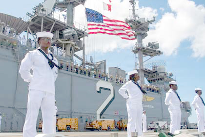 Sailors and Marines aboard the amphibious assault ship USS Essex man the rails while transiting into Pearl Harbor, Hawaii, for Rim of the Pacific 2026, June 21, 2026. The Rimpac multinational exercise fosters relationships critical to ensuring global maritime security. U.S. Navy photo by Navy Petty Officer Ivan A. Garcia 